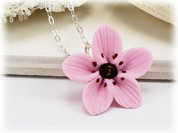 Petite hand sculpted 2cm Pink Cherry Blossom on a hand wired bail. A sweet little adoring necklace perfect for those who love Cherry Blossoms like me! -Original hand sculpted polymer clay flowers -Durable, water-resistant -No molds, no paint, no glue -2cm Flower (about 3/4 inch) -16 inch or 18 inch cable chain -Silver-plated, Gold-plated, Antique Brass, 925 sterling Silver or 14k Gold Filled View matching collection at: https://www.etsy.com/shop/strandedtreasures/search?search_query=cherry+bloss Handmade Pink Necklace For Mom, Handmade Pink Pendant Flower Necklace, Whimsical Flower Necklace For Gifts, Cute Pink Flower Necklace For Gift, Handmade Pink Flower Necklace Gift, Pink Flower Necklace For Mom, Handmade Pink Flower Necklace As Gift, Cute Flower Necklace Gift, Cute Flower Necklace For Gifts