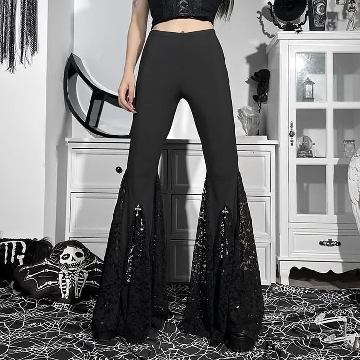 Discover the allure of the Witchy Gothic Lace Flare Pants. With delicate lace detailing, a high waist, and crosses adorning the knees, these pants embody dark and mystical style. Crafted from soft, breathable fabric, they offer comfort and durability. Perfect for rituals, festivals, or nights out, pair them with a crop top, sweater, or coat for an enigmatic presence that reflects your witchy gothic personality. Soft and breathable fabric that is comfortable and durable Cross detail on both sides Lace Flare Pants For Party, Party Bottoms With Lace Trim And Stretch, Party Lace Wide Leg Pants, Party Lace Stretch Pants, Party Wide Leg Lace Pants, Stretch Lace Party Pants, Lace Flare Bottoms For Party, Flare Lace Bottoms For Party, Wide Leg Lace Pants For Party