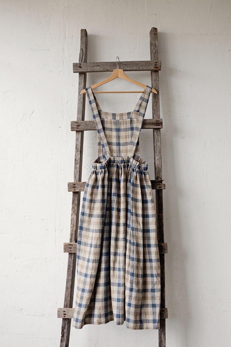 Pinafore dress with flutter sleeves is made from 100% soft and washed linen. Details: - Composition: 100% Oeko-Tex certified linen - Colour: plaid - Pockets - Cross back - Length - 124 cm (49 inches) - Adjustable with buttons - Elastic Waist - Medium weight linen - Linen care: machine wash gentle; tumble dry low, ironing optional - The price is for one pinafore dress, other pictured items are not included Victorian Apron, Apron Dress Pattern, Victorian Aprons, Pinafore Dress Pattern, Linen Pinafore Dress, Linen Pinafore Apron, Cottage Dress, Linen Pinafore, Pinafore Apron