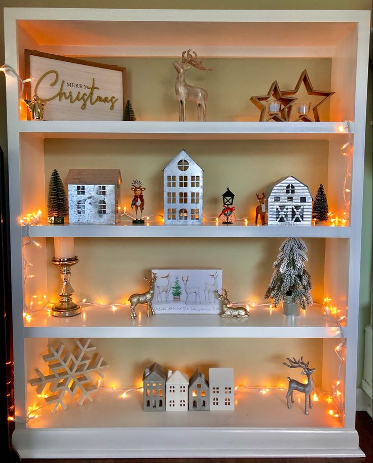 the shelves are decorated with christmas decorations and lights, including figurines on them