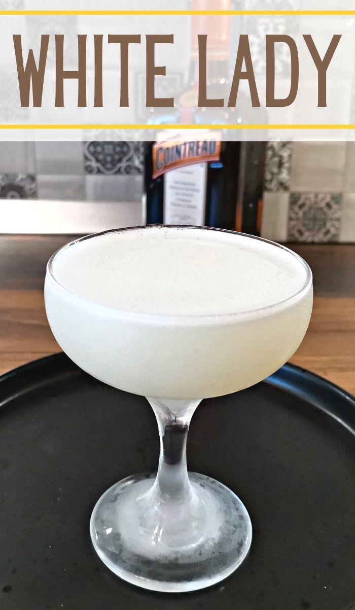 a white lady cocktail sitting on top of a black tray