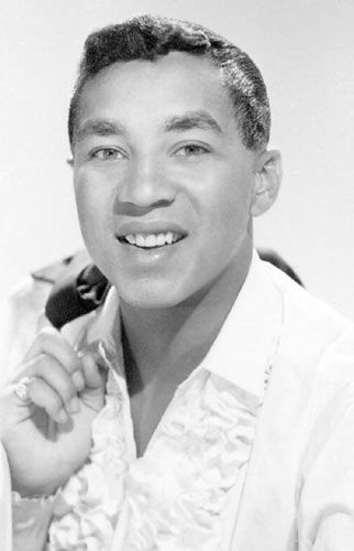 a black and white photo of a man smiling