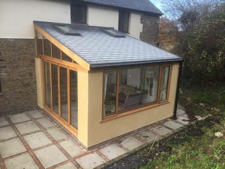 a small house with a tiled patio next to it