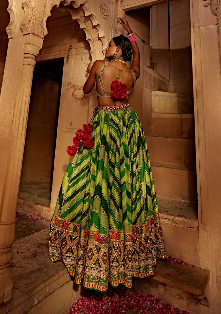 Make a style statement like a traditional diva in this alluring lehenga set featuring a geometrical print skirt with a multi-colour embroidered border and an intricately embroidered blouse styled with a coordinated dupatta. Green Floor-length Palazzo Set For Navratri, Green Georgette Lehenga With Cutdana, Green Georgette Lehenga With Cutdana Details, Green Palazzo Set With Unstitched Blouse For Reception, Green Palazzo Set With Unstitched Blouse For Festivals, Green Bohemian Anarkali Set, Bohemian Green Georgette Anarkali Set, Bohemian Green Georgette Sharara, Green Bohemian Semi-stitched Sets