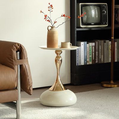 a living room with a couch, chair and television set in it's corner