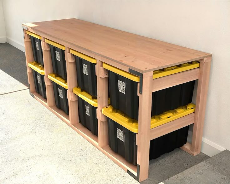 a wooden shelf with several bins on it and some yellow plastic containers in front of it