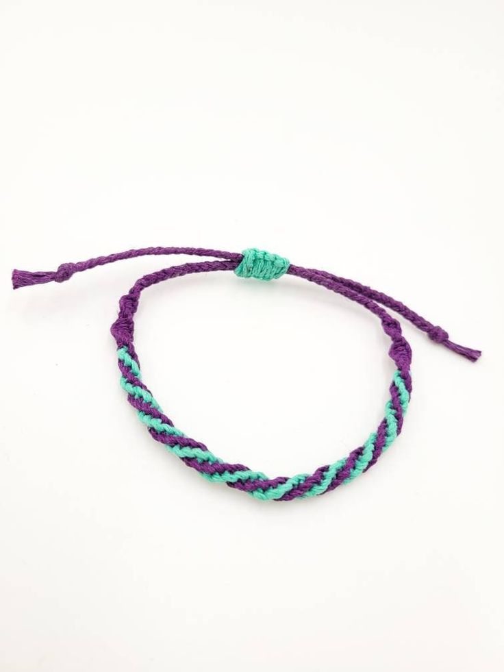 a purple and blue bracelet with two strands on it, one is in the shape of a