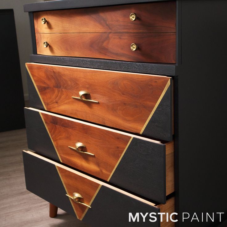 a black and brown dresser with gold handles