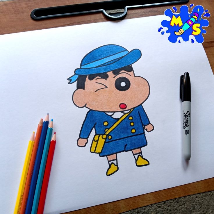 a drawing of a cartoon character on paper with colored pencils next to it