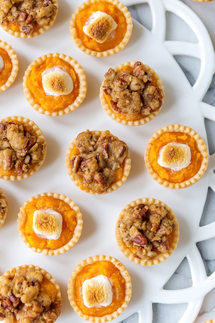 mini pies are arranged on a white platter and ready to be eaten for dessert