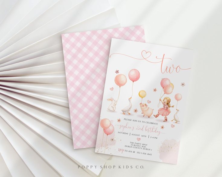 two pink and white paper fans next to each other