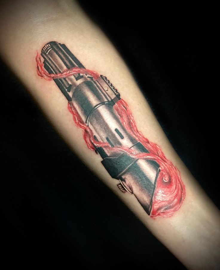 a tattoo on the arm of a man with a red light coming out of it