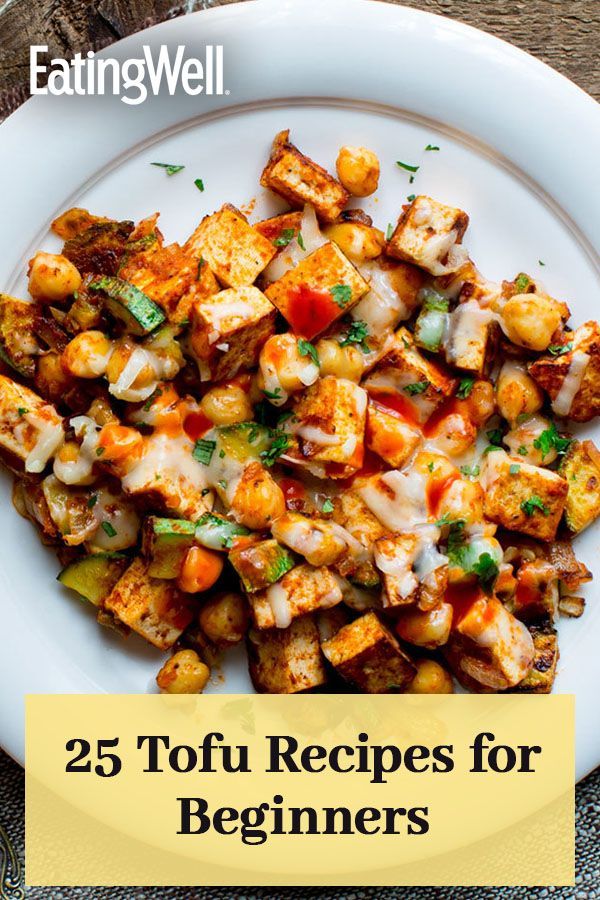 a white plate topped with tofu and vegetables