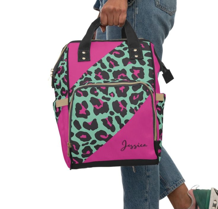 Personalized Leopard Print Backpack Diaper Bag Hot pink and Mint Green Animal Print Bag Bright and Bold Colors This bag is perfect for work or school. Very roomy for laptop,, electronics, chargers, files, books, snacks... you name it! Front pocket storage for your bottled drinks to stand and keep all your valuables dry.  Perfect for running errands or going on day trips with toddlers, this multi-purpose diaper backpack will fit everything from milk bottles to wet wipes to, you guessed it, diapers. It's made from lightweight, high-grade nylon to keep it sturdy for more than one generation. The open design has one main pocket with a zipper, three elastic pockets, and one net pocket for quick storage. .: 100% high-grade nylon .: One size:  15.0" × 10.8" × 6.7'' (38.1cm × 27.4cm × 17.0cm) .: A School Bags With Animal Design For Back To School, Pink Laptop Bag For School, Pink Shoulder Laptop Bag For Daily Use, Back To School Animal Design Backpack, Casual Pink Shoulder Diaper Bag, Animal Design School Backpack, Back To School Backpack With Animal Design, Trendy Pink Diaper Bag, Pink Rectangular Diaper Bag For On-the-go