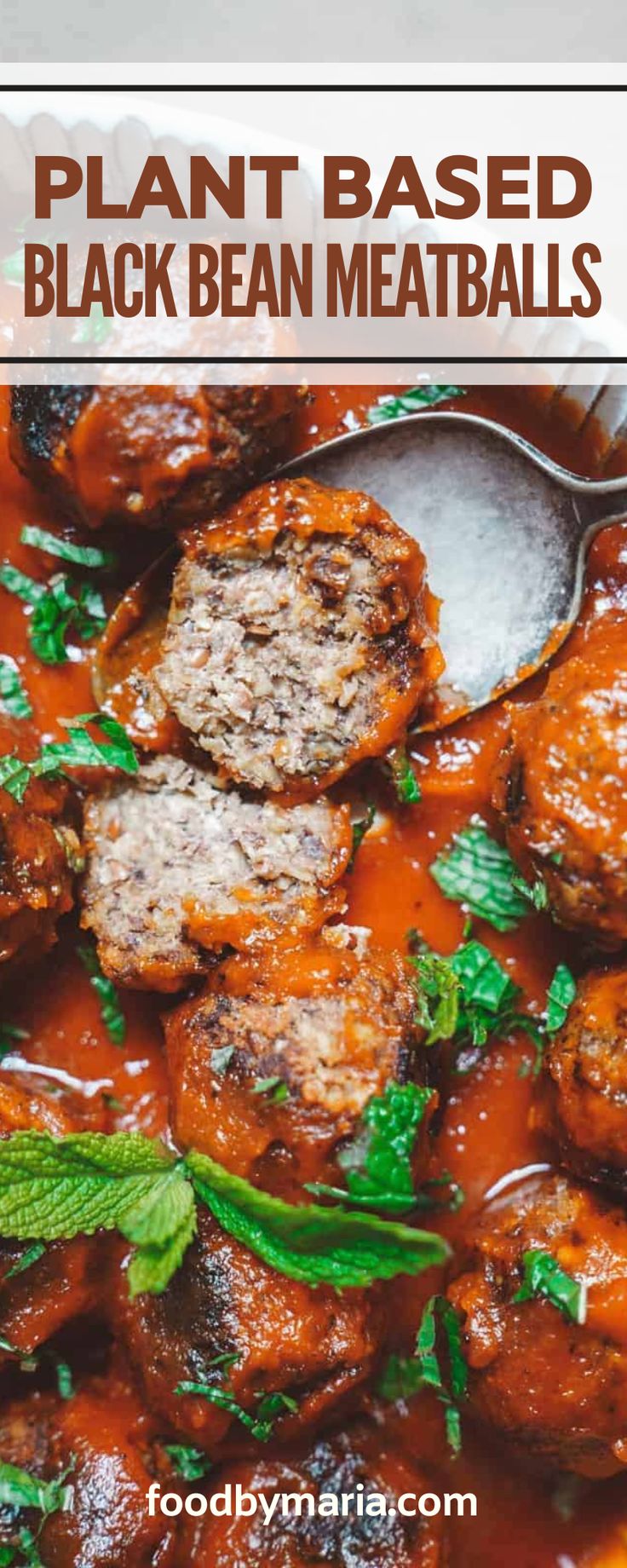 meatballs in tomato sauce with mint leaves on top and text overlay that reads plant based black bean meatballs