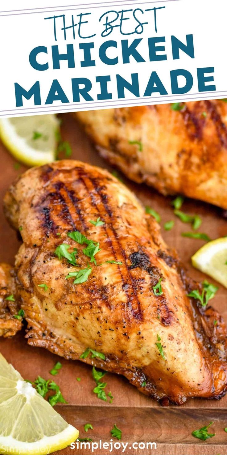 grilled chicken with lemon wedges and parsley on a cutting board, ready to be served