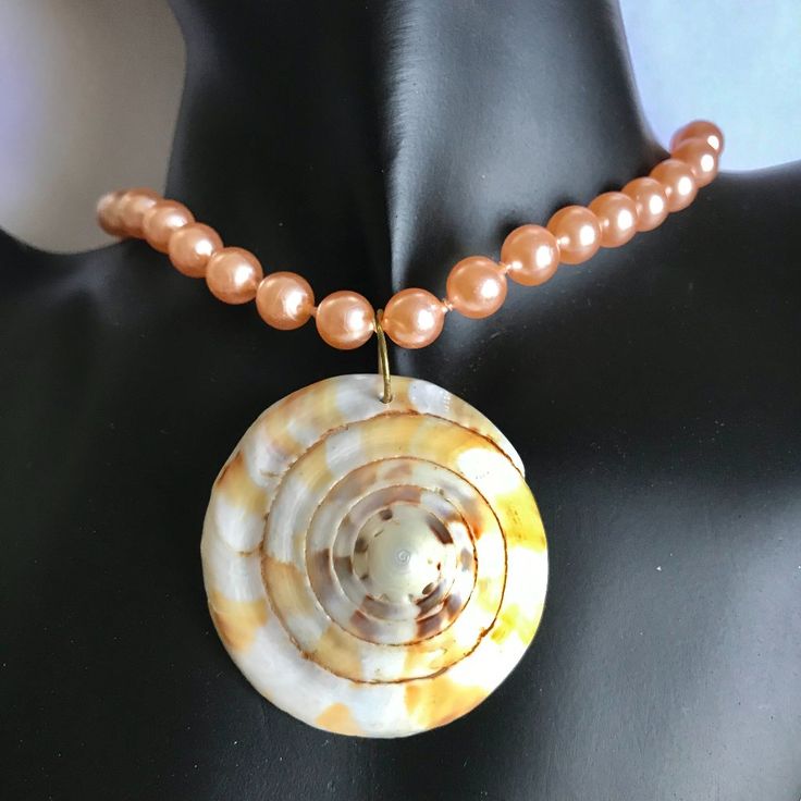 Natural Nautilus Shiva Shell Pendant Choker Pearl Necklace Art By The Sea 16 Inch Hand Knotted Vintage Plastic Peach Pearls From Hong Kong. 2 Inch Removable Extender Included Making This 18 Inches Total. New Condition From Old Store Stock. Visit Our Store For More Great Sea Life Jewelry. Thanks For Looking. Peach Round Necklace For Gift, Peach Round Necklace Gift, Peach Necklace Gift, Round Peach Necklace For Gift, Gift Round Peach Necklace, Pink Shell Necklace With Round Beads As Gift, Pink Shell Necklace With Round Beads, Pink Shell Necklace With Round Beads For Gift, Pink Round Beads Shell Necklace As Gift