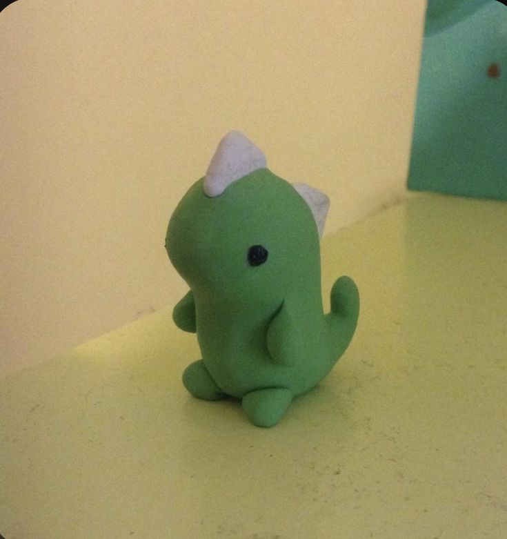 a green toy sitting on top of a counter