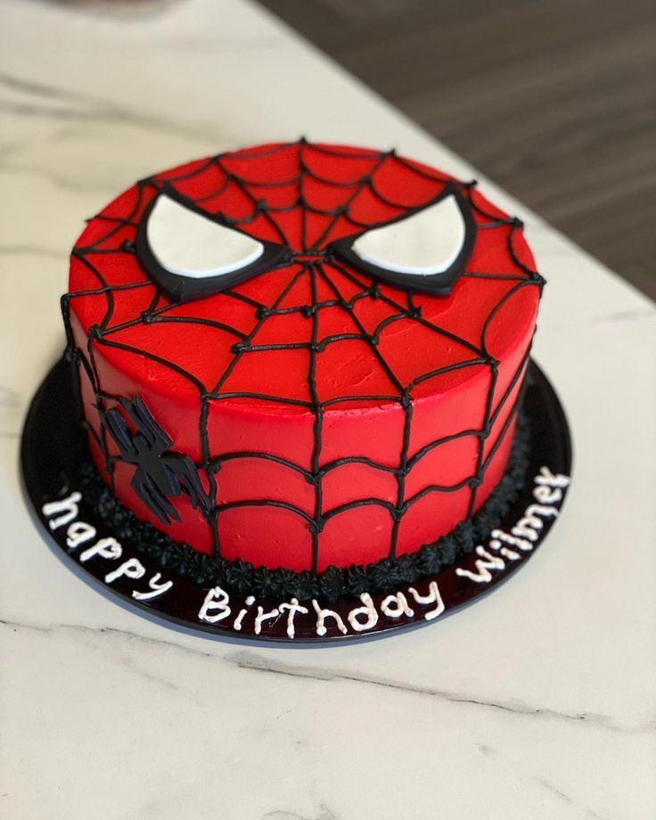 a spiderman birthday cake on a table