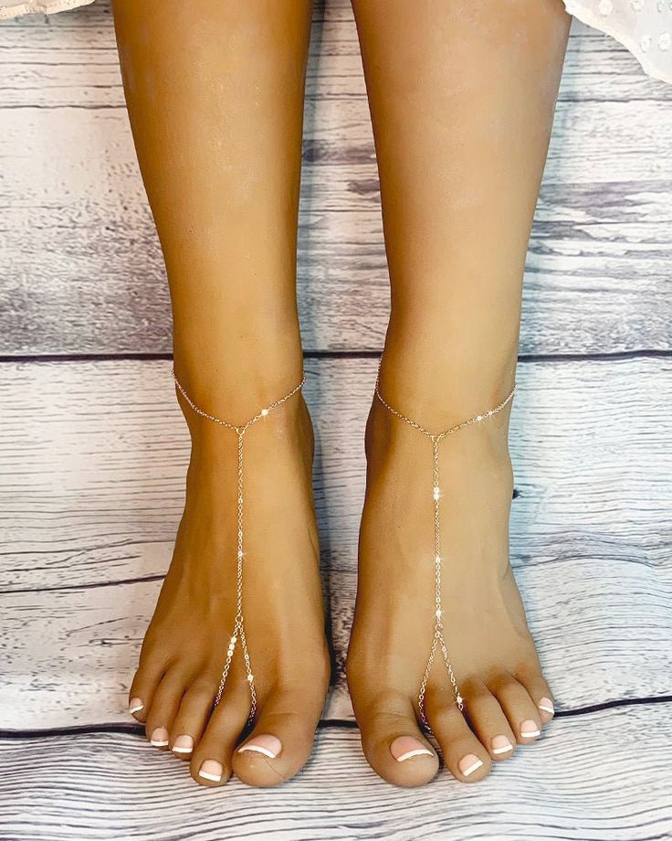 "Leona Rose Gold Barefoot sandals are handcrafted using 1.5 mm cable chain, plated in rose gold hues. These stunning foot jewels are perfect for someone who loves minimalist jewelry and that \"bare there\" feel to their favorite pieces. Great gift for bridesmaids or your girlfriends for their birthday / special days. Adjustable closure on the back accommodates all foot sizes. Sold as a pair. Gift wrapped. Shipped in 2 business days from purchase. All rights reserved @ Bare Sandals LLC 2020." Dainty Rose Gold Summer Jewelry, Toe Ring Barefoot Sandals As Gift, Elegant Adjustable Gold Barefoot Sandals, Elegant Barefoot Sandals With Ankle Strap As A Gift, Elegant Ankle Strap Barefoot Sandals As Gift, Adjustable Gold Barefoot Sandals As Gift, Silver Toe Ring Barefoot Sandals As Gift, Silver Toe Ring Barefoot Sandals, Delicate Silver Anklets For Summer