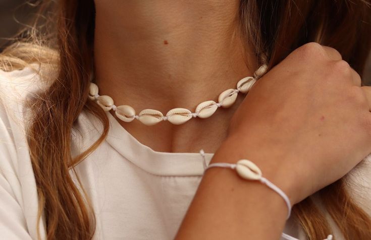 Summer cowrie set: choker necklace  is made of natural cowrie seashells  bracelet is made nylon cord and cowrie shell For all size Casual Shell Jewelry Gift, Adjustable White Cowrie Shell Choker, Adjustable Casual Cowrie Shell Necklace, Casual Beach Jewelry With Cowrie Shell, Casual Cowrie Shell Jewelry For Beach, Casual Cowrie Shell Jewelry For Festivals, Casual Cowrie Shell Beach Jewelry, Handmade Cowrie Shell Decor, White Shell Choker Necklace For Summer