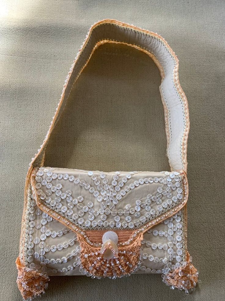 "Buba, beaded leather shoulder bag, in beautiful as close to new as you can get, peach, beige, mother of pearl shaded beads, is a stunning statement of bold \"Pretty Woman\" style." Embellished Beige Clutch Shoulder Bag, Beige Embellished Clutch Shoulder Bag, Evening Cream Embroidered Shoulder Bag, Cream Embroidered Shoulder Bag For Evening, Evening Embroidered Cream Shoulder Bag, Evening Beige Embellished Shoulder Bag, Beige Beaded Festival Bags, Beige Embellished Rectangular Shoulder Bag, Traditional Embellished Beige Shoulder Bag