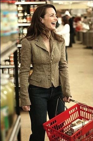 a woman holding a shopping cart and laughing