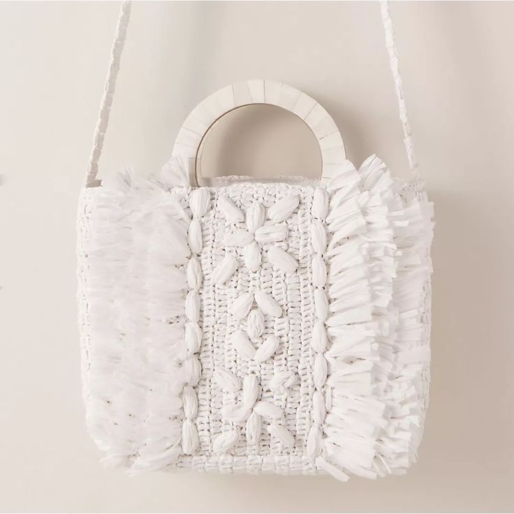 Brand New With Tags! Sold Out Online. Cleobella - From Anthropologie Beach-Ready And Oh-So-Chic, This Raffia Tote Features Abundant Texture Courtesy Of Fringe And Woven Florals. A Wood-Inlay Top Handle And A A Shoulder Strap Complete The Look. Part Of A Special Collection From Bhldn. For The Full Assortment, Visit Bhldn.Com. Loop Closure 8"H; 12"W; 3"D 16" Strap Drop Raffia, Canvas, Wood Imported White Top Handle Crochet Bag For Shopping, Chic White Woven Straw Bag, Chic White Straw Bag With Braided Handles, White Woven Straw Bag, White Straw Bag With Braided Handles, White Crochet Beach Bag With Top Handle, White Woven Top Handle Bag, White Top Handle Crochet Bag For Beach, White Top Handle Bucket Bag For Summer