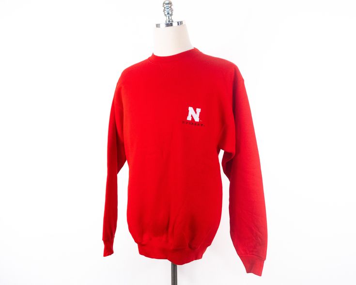 "Nebraska sweatshirt in new condition. Size: multiple sizes, please see measurements Measurements taken with garment laid flat. MEDIUM Shoulder: 21.5\" Chest: 21.5\" Length: 29.5\" Sleeve: 25.5\" LARGE Shoulder: 23.5\" Chest: 23.25\" Length: 31\" Sleeve: 25.5\" X-LARGE Shoulder: 25.5\" Chest: 25\" Length: 31\" Sleeve: 25.5\" Material: 80% Cotton 20% Fortrel Polyester Label: Olympus Superweight Please message me with questions or for additional photos. View other items from my shop here: www.etsy Nebraska Sweatshirt, College Gear, Red Crewneck, Vintage University, Ncaa Football, Nebraska, Ncaa, Crewneck Sweatshirt, High Fashion