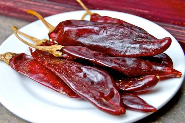 some red peppers are on a white plate