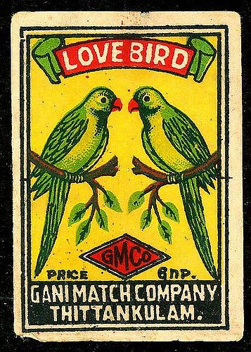 an old matchbox with two green birds on it's back and the words love bird