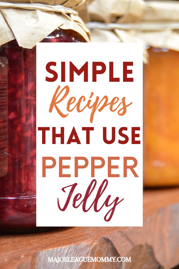 a jar filled with beet jelly sitting on top of a wooden table next to a sign