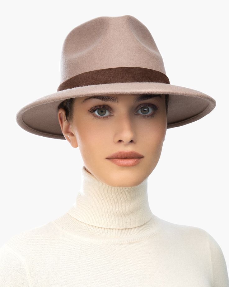 The versatile hand-blocked wool felt fedora banded with lamb leather is water-repellent. The Crown is fully lined. The elasticized inner band fits most. Packable. Made in the USA of imported materials. Sustainable wool is shorn and milled from multi-use sheep living on small farms under the most humane conditions. Designed and finished in USA Hand-blocked by skilled artisans Highest Quality Materials Sustainable wool Brim Span: 3"(7.6cm)