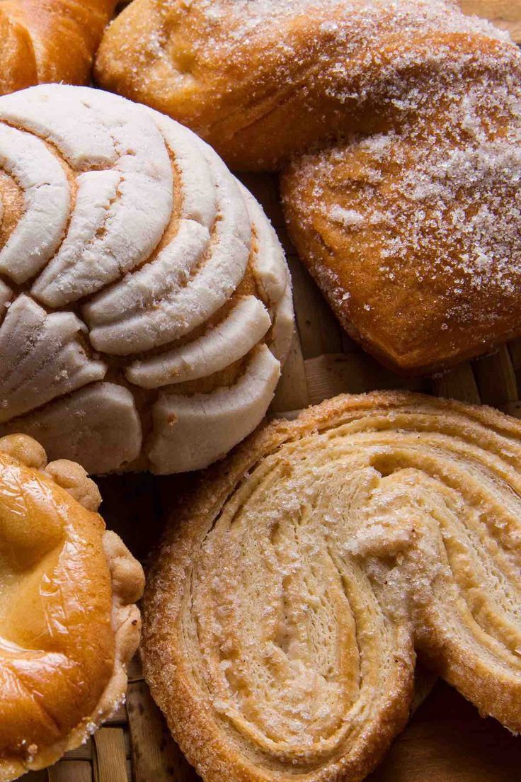 several different types of pastries sitting on a wooden table top next to each other