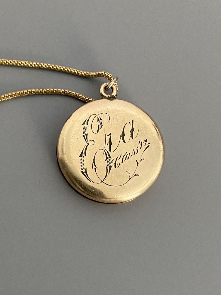 "Weight: 11.9g Dimensions: 1\" round, 18\" chain Hallmarks: Makers mark L & M Although these lockets were patented in the year 1902, this particular locket states on its backside that it is from the 'class of '12' dating it to a decade later. This is a very unique locket in that it has 3 windows and folds like an accordion. All bezels are present and the two clear windows inside the front and back covers are still present. The locket measures 1\" round and comes on an 18\" GF chain. Very lig Antique Medallion Locket Necklace Stamped 14k, Victorian Round Locket Necklace Stamped 14k, Vintage 14k Gold Locket Necklace, Vintage 14k Gold Locket Necklace Stamped 14k, Victorian Engraved Yellow Gold Locket Necklace, Antique Hallmarked Locket Necklace For Anniversary, Hallmarked Antique Gold Locket Necklace, Antique Engraved Yellow Gold Locket Necklace, Hallmarked Yellow Gold Vintage Locket Necklace