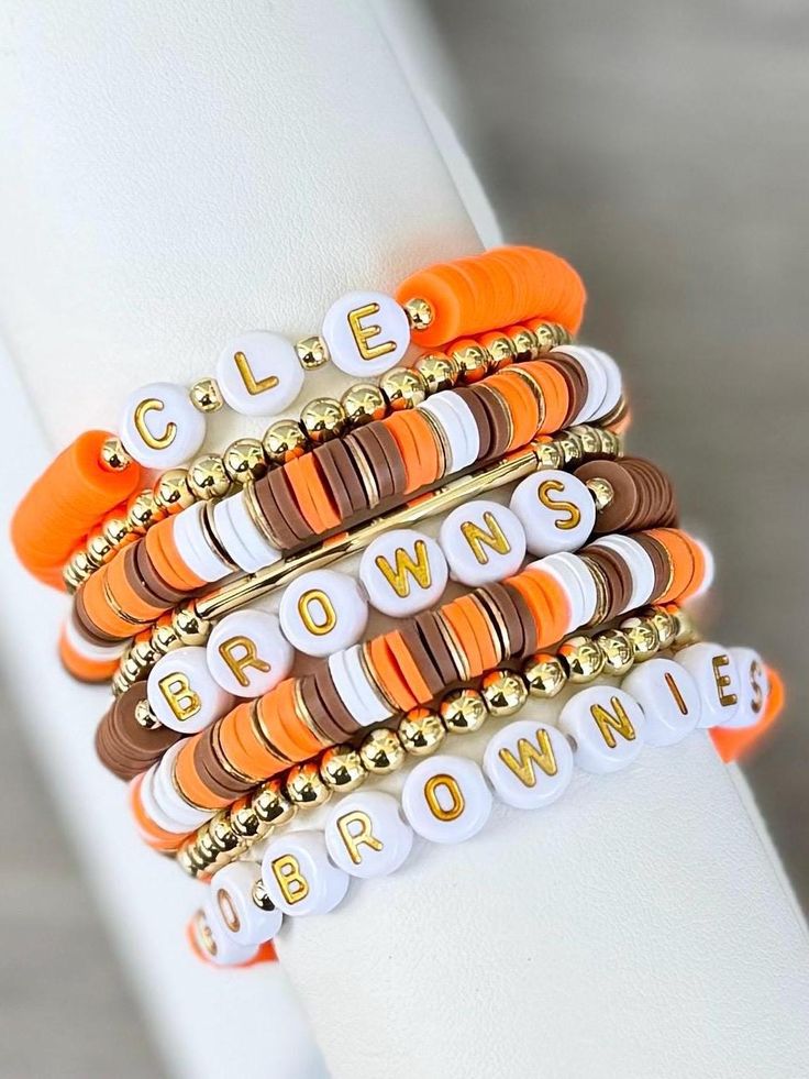 CLEVELAND BROWNS stackable bracelets are perfect for game days, or any day!  🧡 All gold spacer beads are made of 18k gold filled beads & are hypoallergenic. Some color shades may vary some.  EACH BRACELET SOLD SEPARATELY. Right colors, but wrong team? Message seller to customize yours with your favorite team, mascot or slogan.  INSTRUCTION: 1. Select wrist size from the drop down menu. Each bracelet is custom made to size. (Please see photo for wrist sizing measurement.) 2. In the "Personalization" section, please notate any changes you would like to make. Examples of this would be band color or word changes.  **If no changes are made in the personalization section, bracelets will be made like photo.  📦📫FREE SHIPPING ON ALL DOMESTIC ORDERS OF $35 OR MORE! Care:  * Keep bracelets dry and Fall Bracelets, Bracelets Orange, Keep Bracelet, Football Jewelry, Clay Bracelets, Holiday Bracelets, Bracelet Inspiration, Autumn Bracelet, Browns Football