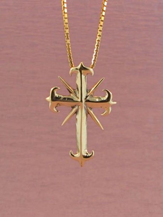 "This detailed Gothic Cross is 1\" long. It's medieval style may not be traditional, but the message is eternal. The gold chain is not included in the price. If you would like a solid 14k gold chain please select the stye and length from the option menu. If you would prefer a different style or length please contact us. All Marty Magic Jewelry is packaged in a beautiful box embossed with the gold foil Marty Magic dragon logo. Perfect for any occasion! Designed in California by Marty Magic. Made Gothic Gold Cross Pendant Jewelry, Gold Gothic Engraved Necklace, Medieval Style Gold Engraved Necklace, Gothic Gold Engraved Jewelry, Gold Gothic Jewelry For Formal Occasions, Gothic Gold Jewelry For Formal Occasions, Medieval Engraved Cross Jewelry, Medieval Gold Jewelry Gift, Medieval Style Gold Jewelry For Gift