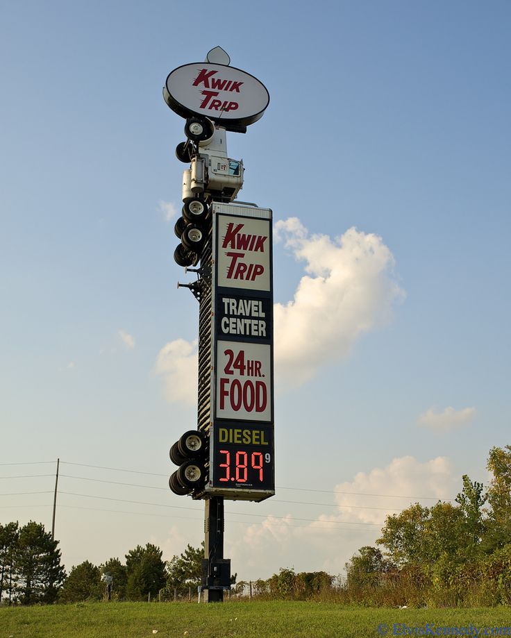 a sign for a trip center in the middle of a field