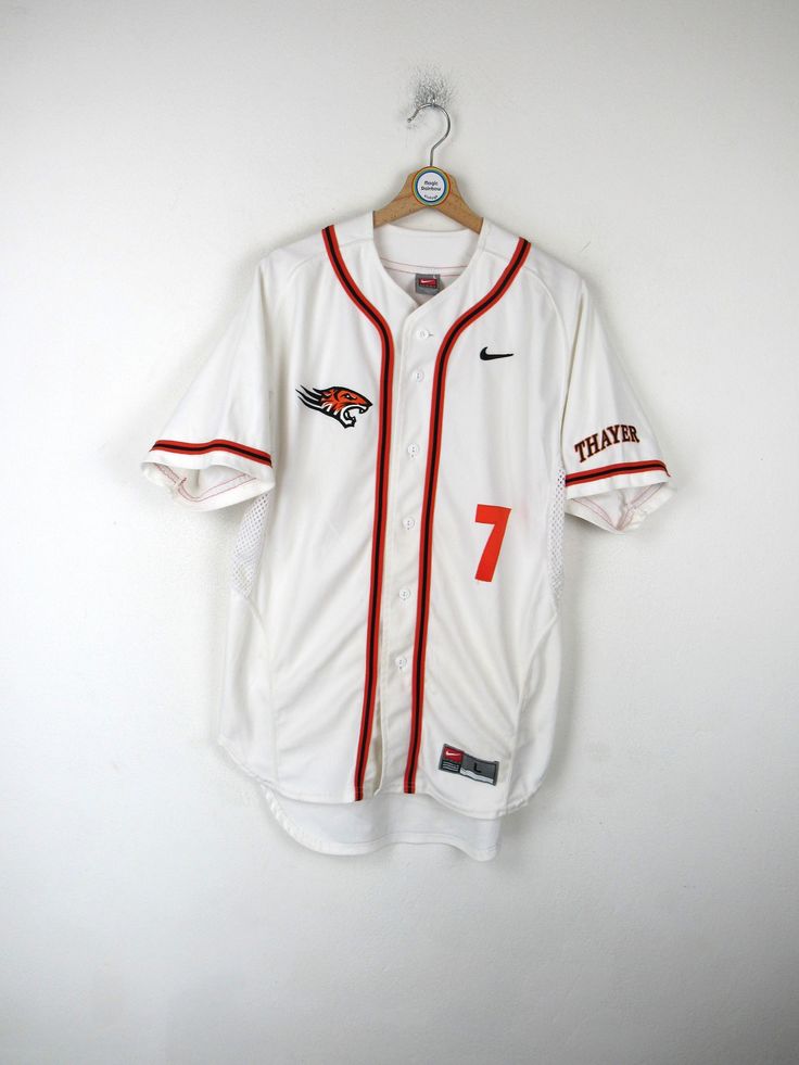 a baseball jersey hanging on a hanger with the number seven printed on it's front