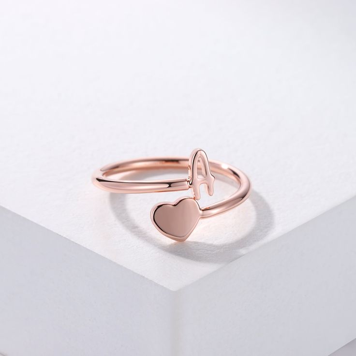 This ring is certain to be enjoyed. Created for special occasion, showcases a letter of your choice, show your love for the important people in your life with this charming Initial Heart ring. Material : 925 sterling silver Finish : 18k Gold - Rose Gold - Sterling silver Personalized Elegant Rose Gold Midi Rings, Elegant Personalized Rose Gold Midi Rings, Personalized Dainty Initial Ring In Rose Gold, Rose Gold Initial Ring For Promise, Dainty Initials Jewelry For Promise, Personalized Dainty Rose Gold Initial Ring, Dainty Rose Gold Sterling Silver Initial Ring, Dainty Personalized Rose Gold Initial Ring, Rose Gold Jewelry With Initials For Promise