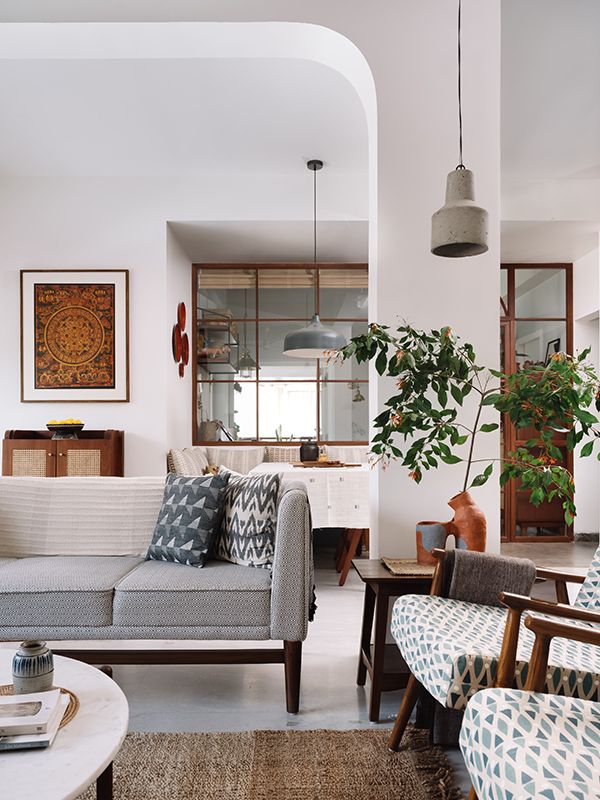 a living room filled with furniture and a potted plant