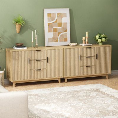 a living room scene with focus on the sideboard and rug in the foreground