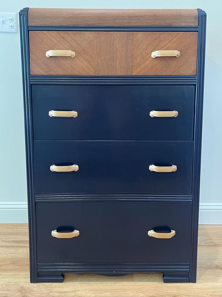 a blue dresser with gold handles on it's sides and wood drawers in the middle