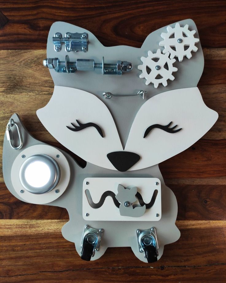 a white clock with a fox face on it