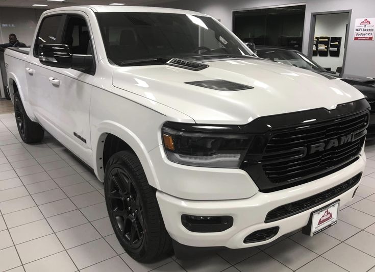 a white truck is parked in a showroom