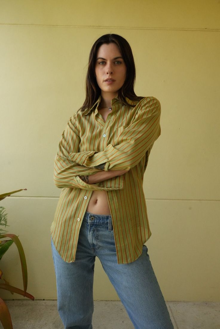 Slim cut stripe shirt with collar and long sleeves.  Bust: 38" Length: 30" Circa: 1970's Condition: Good vintage condition. Normal wear.  Follow us on Instagram for the latest----> http://instagram.com/closetcasevintage @closetcasevintage Please contact us about any questions you may have regarding condition before purchasing.  Please read our store policies. Striped Shirt With Relaxed Fit And Spread Collar, Striped Shirt With Collar For Work, Striped Shirt With Button Closure For Daywear, Collared Striped Shirt For Daywear, Striped Shirt With Placket For Spring, Cotton Tops With Vertical Stripes And Spread Collar, Green Vertical Stripes Shirt For Spring, Green Shirt With Placket For Daywear, Striped Long Sleeve Shirt For Daywear