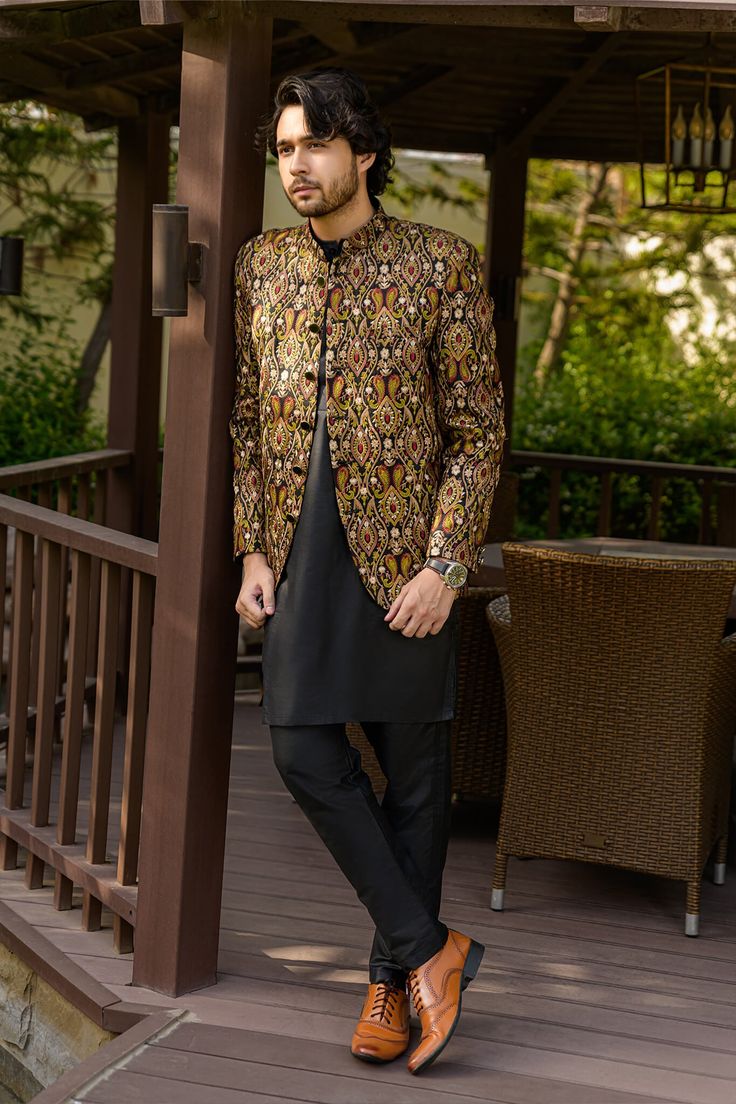 a man standing in front of a gazebo with his hand on his hip and looking at the camera