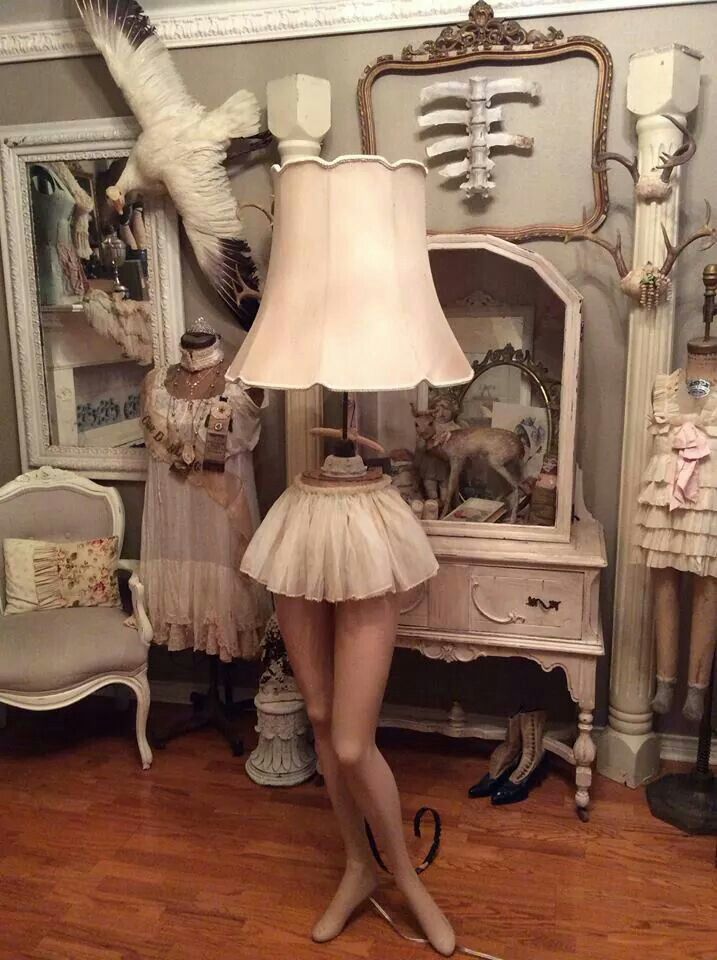 there is a mannequin in front of a table with a lamp on it