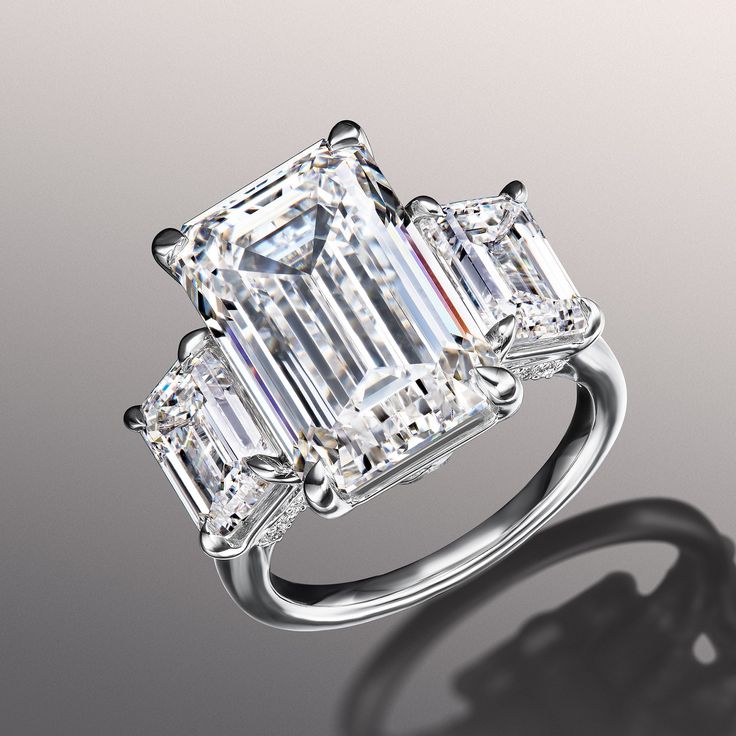 an emerald cut diamond ring with three baguets