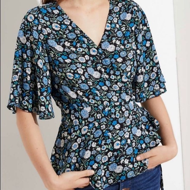 Ann Taylor Loft Floral Blue Wrap Top Is Super Flattering On All Body Types! Blue Floral Print V-neck Blouse, Light Blue Floral Print V-neck Top, Blue Floral Print Top For Day Out, Blue Floral Print Tops For Day Out, Blue Floral Print Short Sleeve Tops, Casual Blue Floral Print Blouse, Blue Floral Print V-neck Top, Blue Floral Print Short Sleeve Blouse, Blue Short Sleeve Blouse With Floral Print